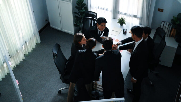 Corporate team in a conference room planning an event, supported by professional audio rentals.