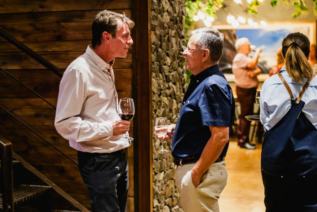 Attendees mingling and networking over drinks during a professional event