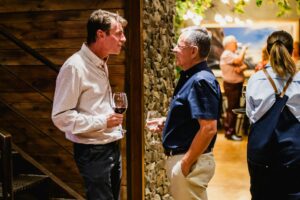 Attendees mingling and networking over drinks during a professional event