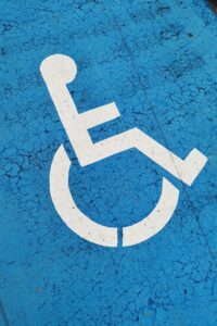 Blue ADA wheelchair accessibility logo highlighting inclusive events with live captioning