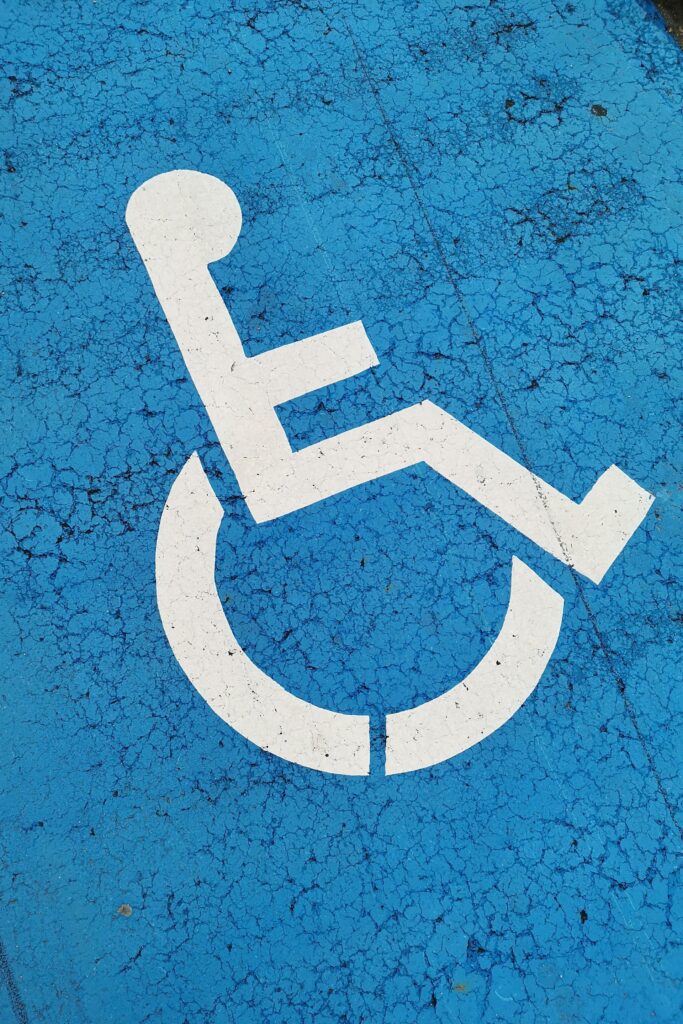 Blue ADA wheelchair accessibility logo highlighting inclusive events with live captioning