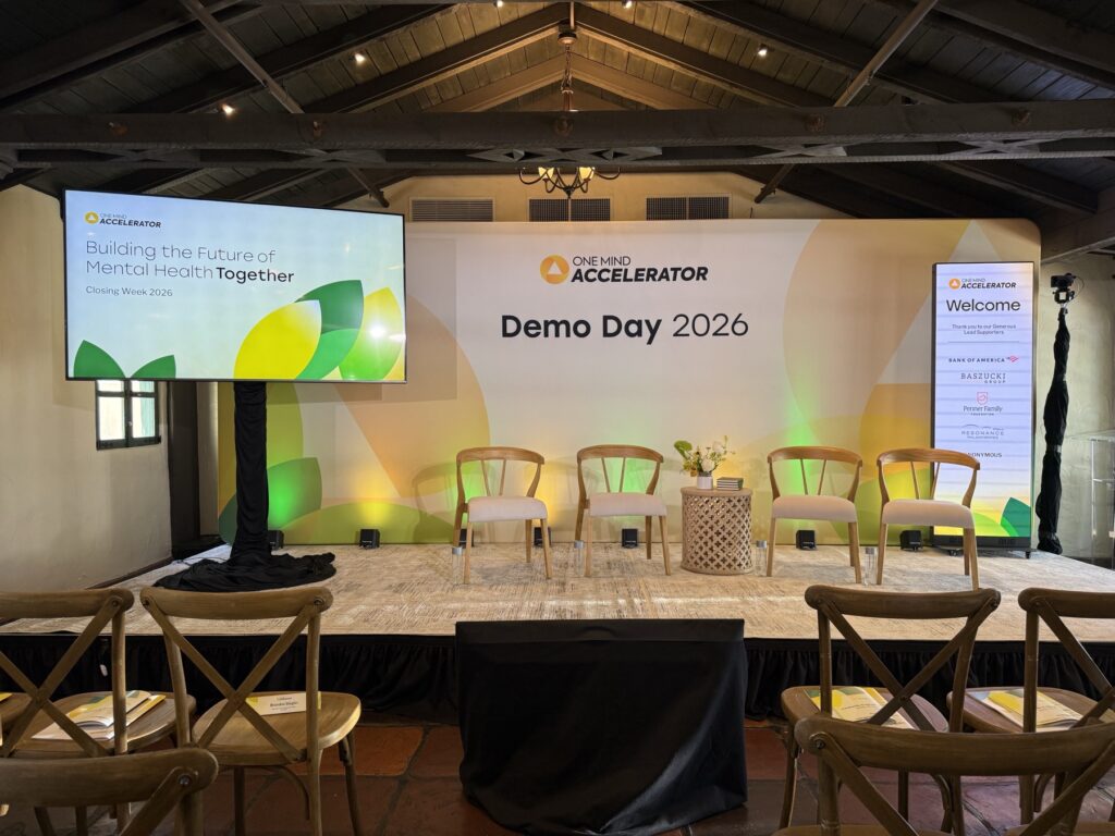 Demo Day 2026 main session stage at Allied Arts Guild, with printed backdrop, side screen and stage lighting set by Westwave AV