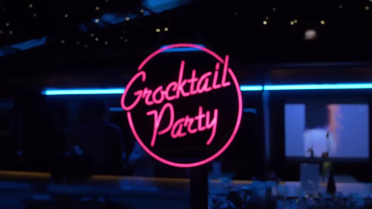 A neon sign and blue neon tube lighting in the blacked-out room